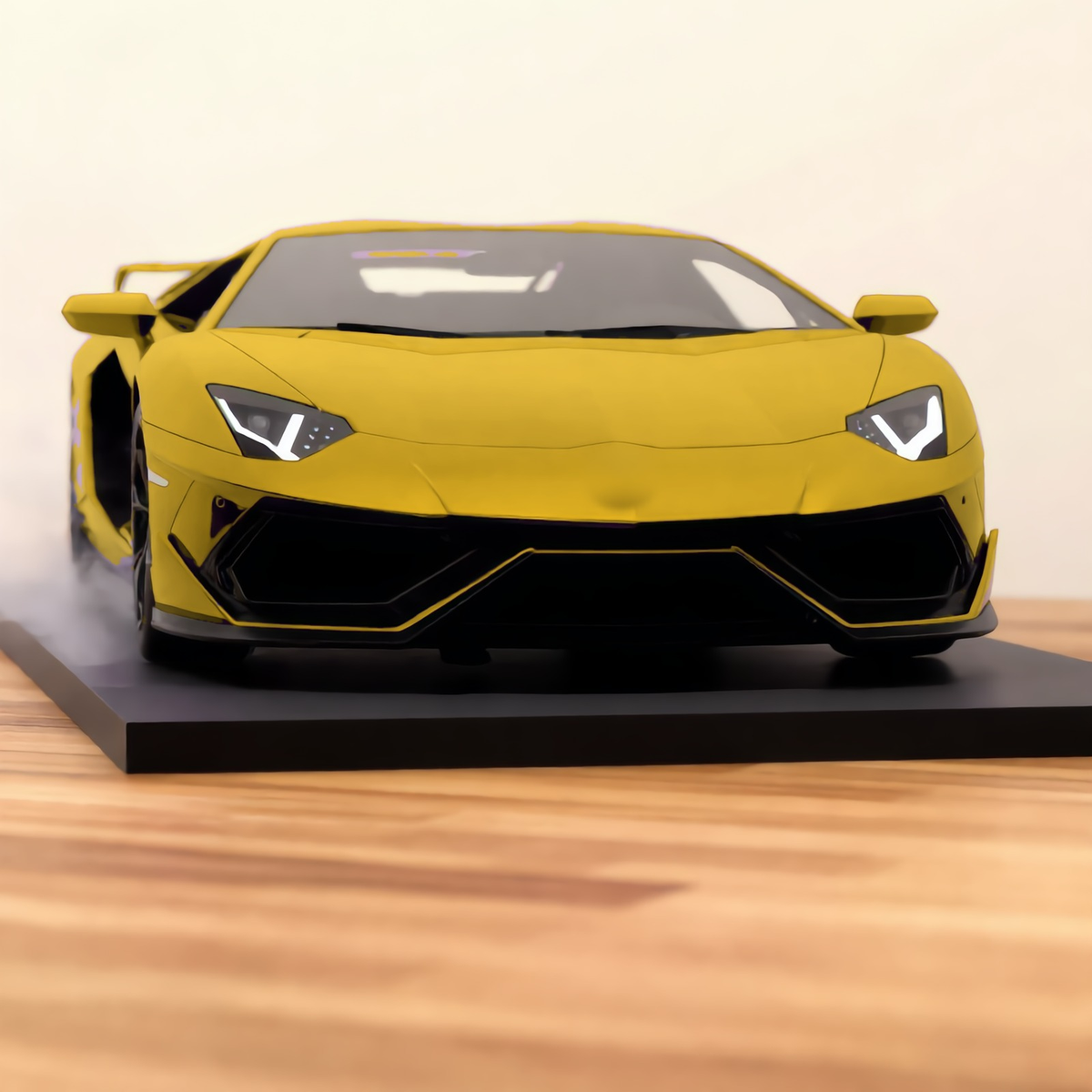 Gold V12 hypercar mist model, front view on a wooden desk