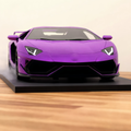 Purple V12 hypercar mist model, front view on a wooden desk